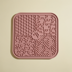 Buddies silicone slow-feed licking mat in dusty pink. Same 4-quadrant slow-feed pattern with paw-print centre.