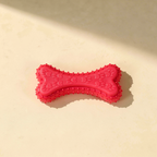 Buddies bite-resistant TPR dog chew bone in rose red / magenta pink. Same chunky paw-print pattern.