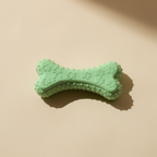 Buddies bite-resistant TPR dog chew bone in fluorescent lime green. Same chunky paw-print pattern.