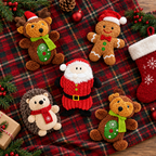Christmas plush dog toys on a tartan blanket